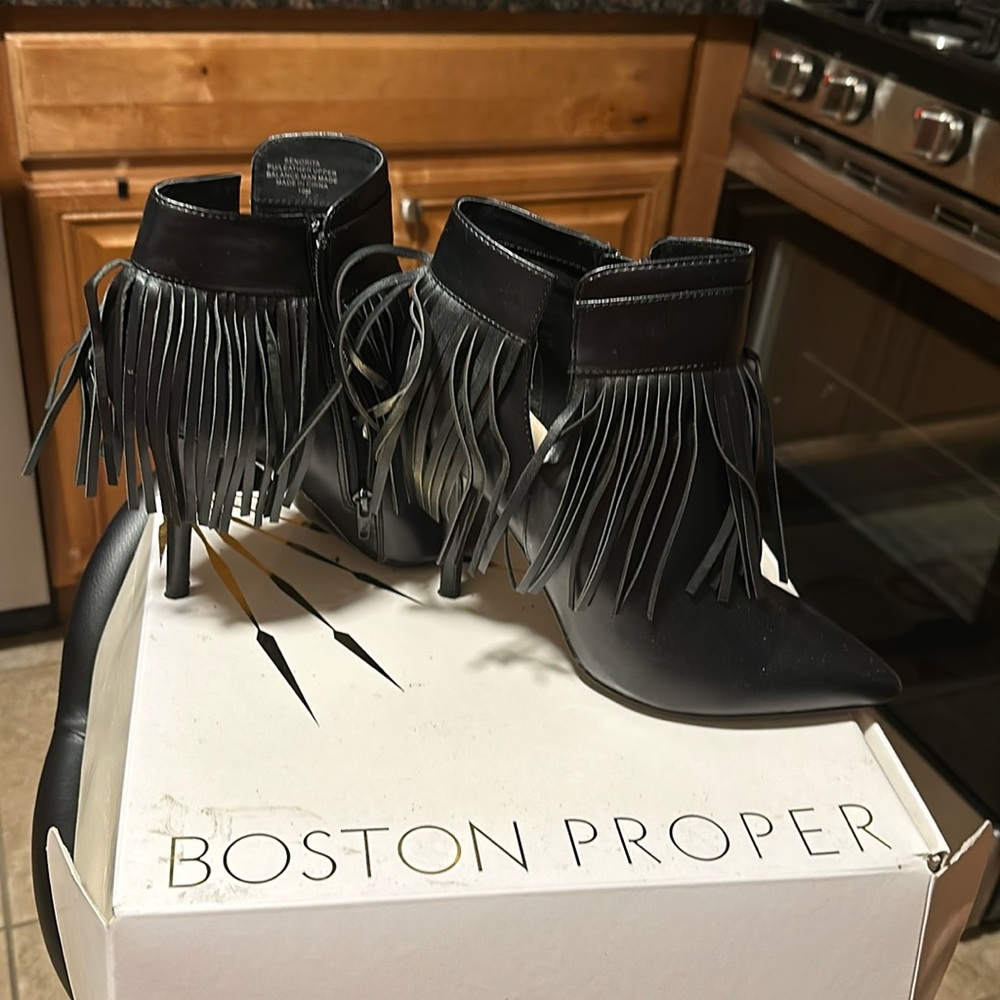 Black leather ankle boots with fringe